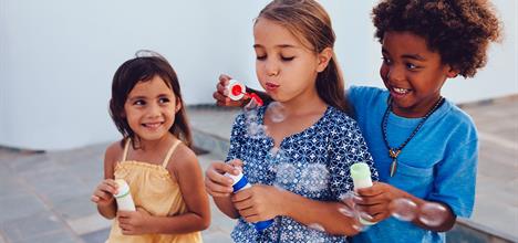 children blowing bubbles